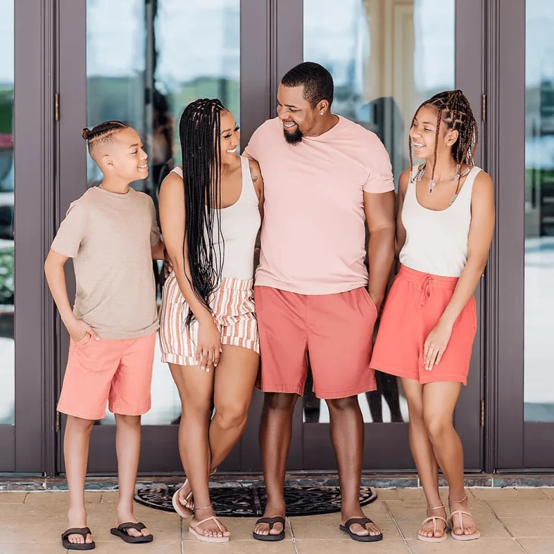 Creator laughs outside of home with partner and 2 daughters